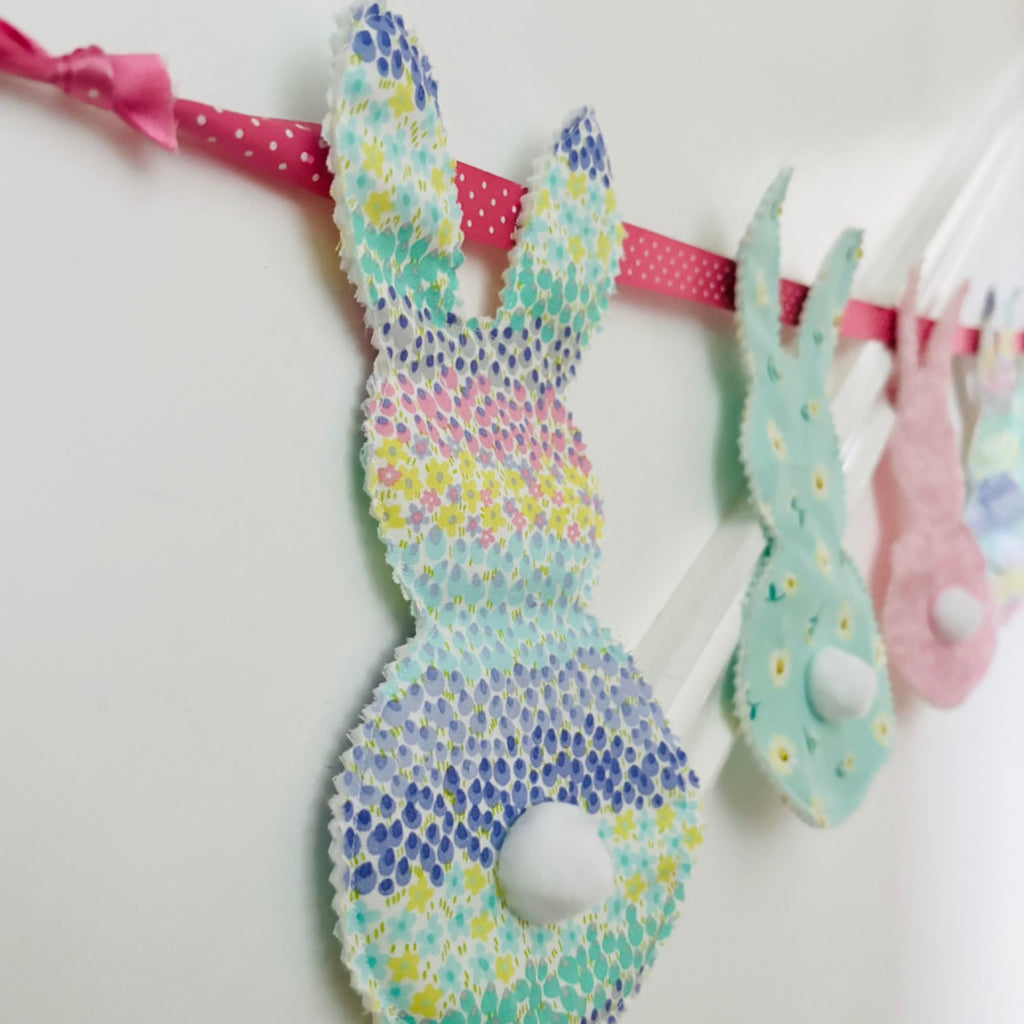 Bunny bunting - patterned bunnies with Pom Pom tails and ribbon holding them up.