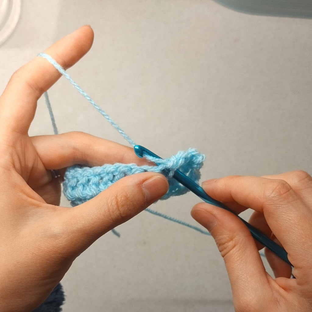 crochet workshop - hands crocheting using a crochet hook and yarn. 