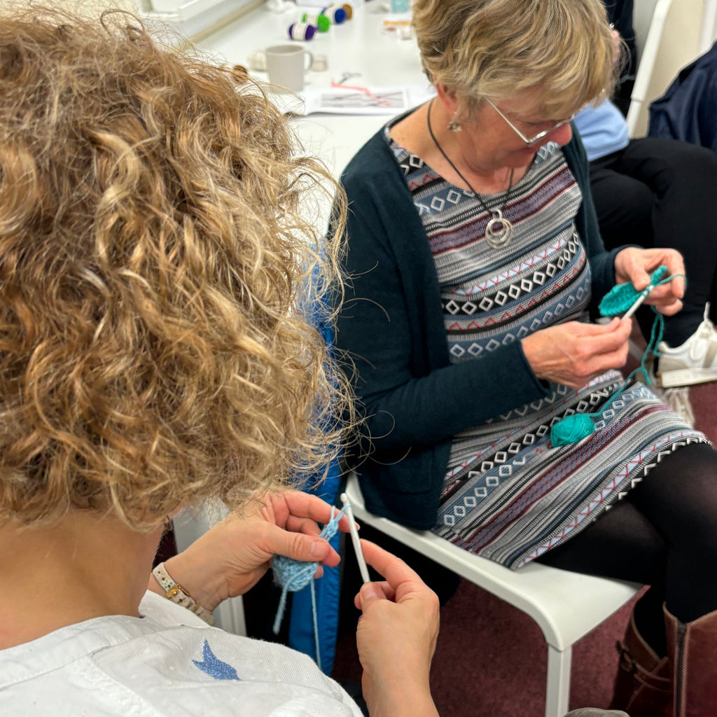two female adults crocheting at pom stitch tassel HQ