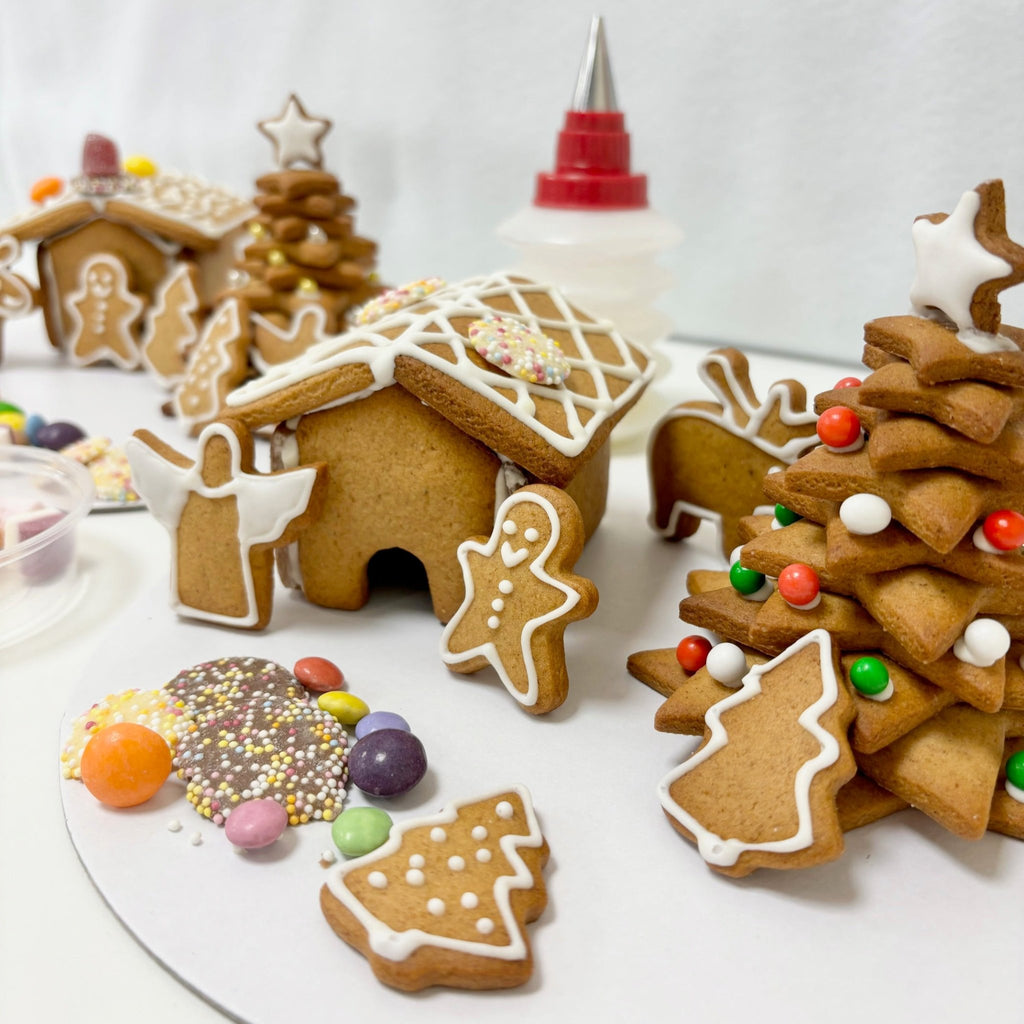 gingerbread biscuits on a tray with a white background and icing bottle.