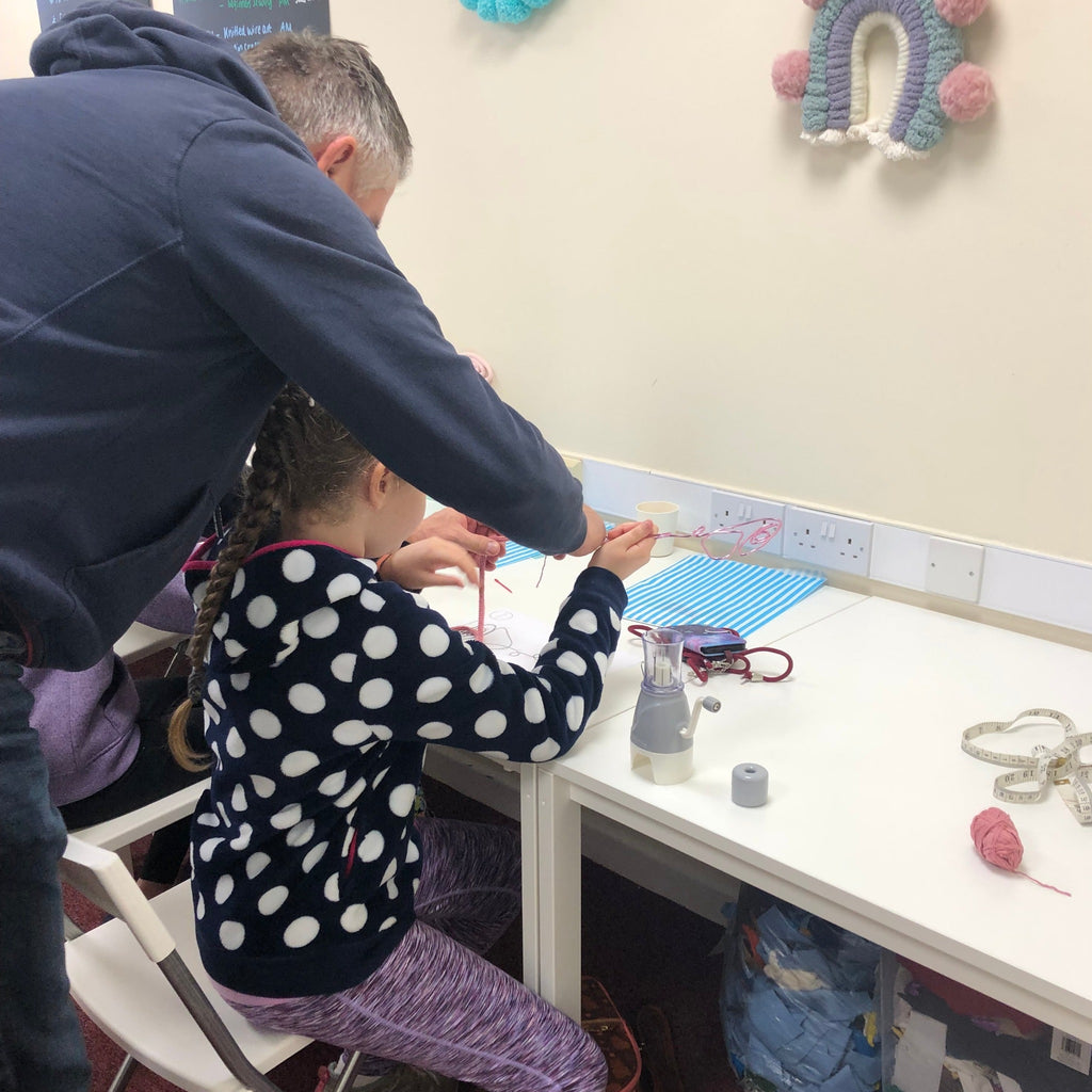 Dad helping his little girl do wire art at pom stitch tassel cuppa and craft session.