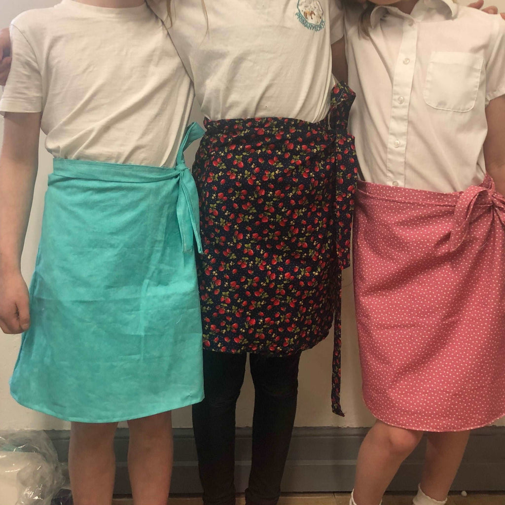 Home Education Stitch Club - three young girls with wrap skirts made in stitch club.