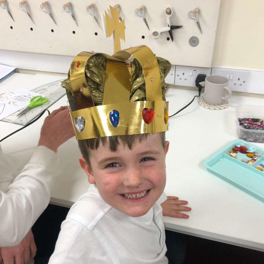 Little boy wearing a diy crown from Pom Stitch Tassel craft club.