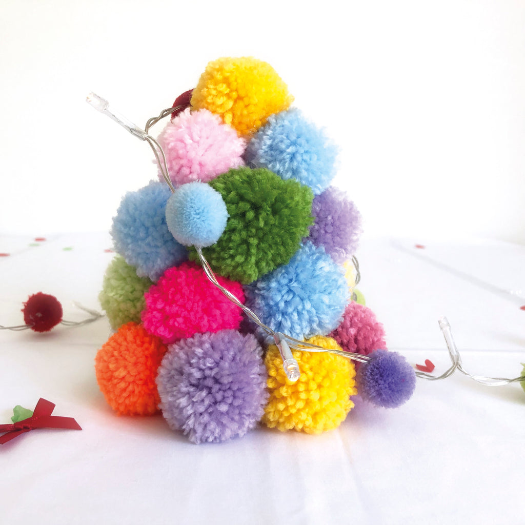 Pom Pom Christmas tree on white background with star battery lights