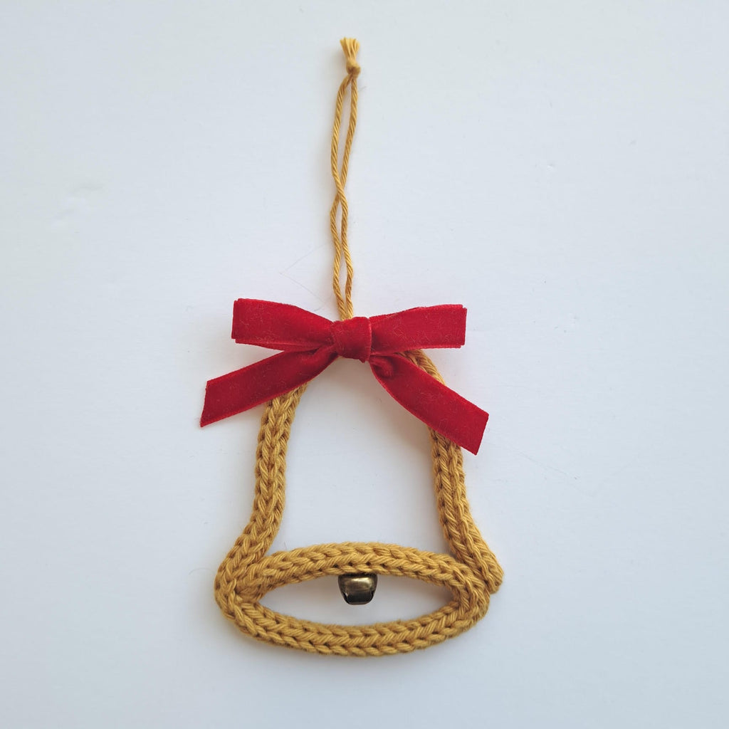 knitted wire bell with red bow and hanger.