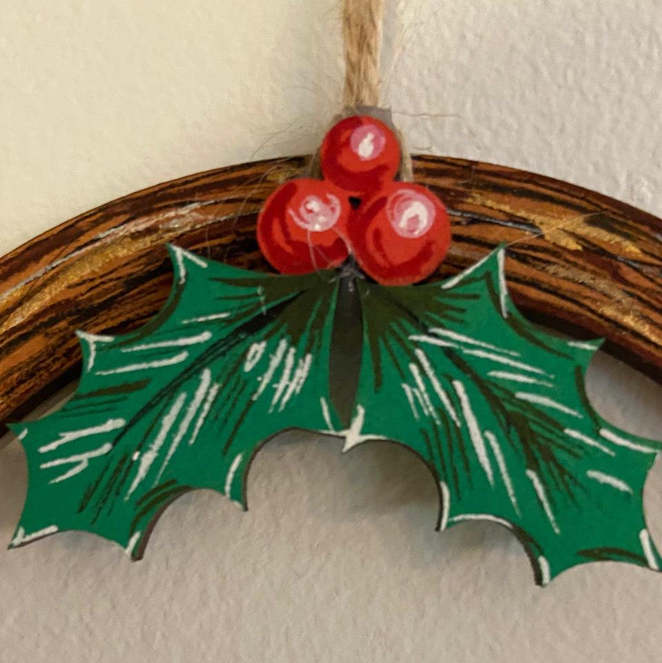 close up of holly on wooden wreath - make your own wooden christmas decorations