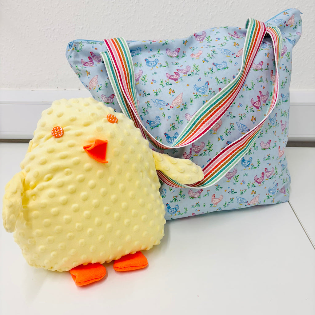 chick softie next to chicken patterned hand sewn bag