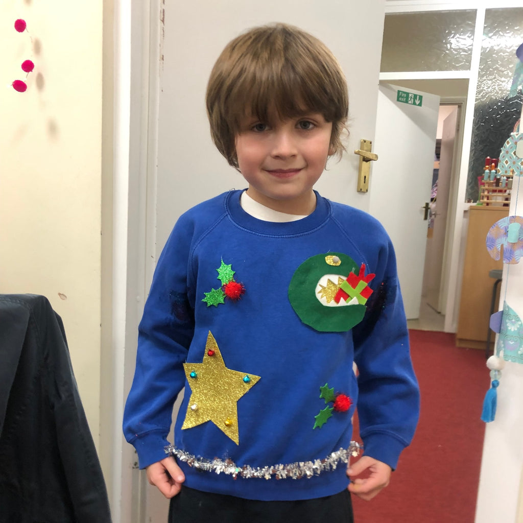 little boy with handmade christmas jumper. make your own christmas jumper with pom stitch tassel