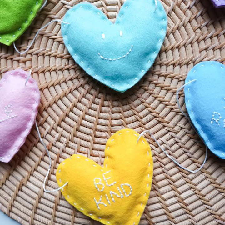 close up of felt heart garland on rattan placemat.