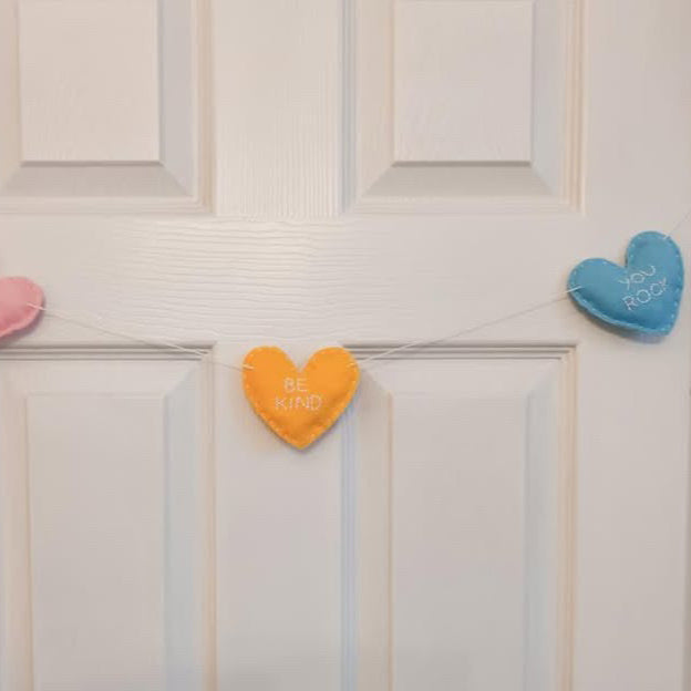 heart garland hanging on white door