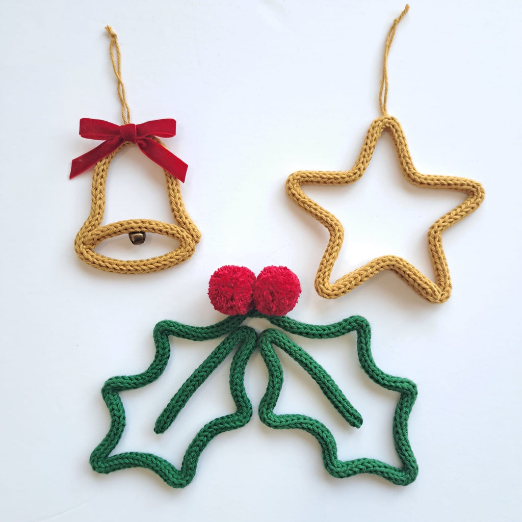 a trio of knitted wire tree decorations - bell, star and holly.